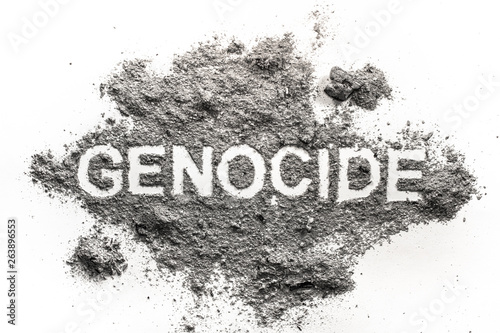 Genocide word written in ash  sand or dust