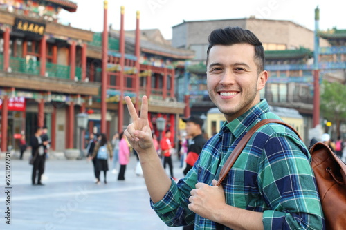 Man showing peace sign from Asian square 