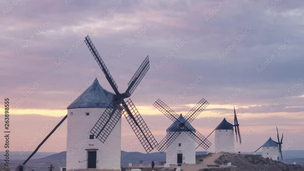 Windmills in Consuegra, Castilla La Mancha during sunset. Clouds with beautiful colors at golden hour.
