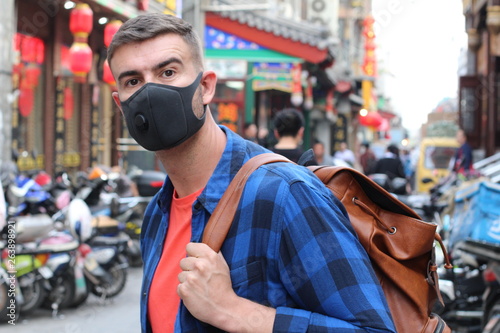 Caucasian tourist using pollution mask in Asia 