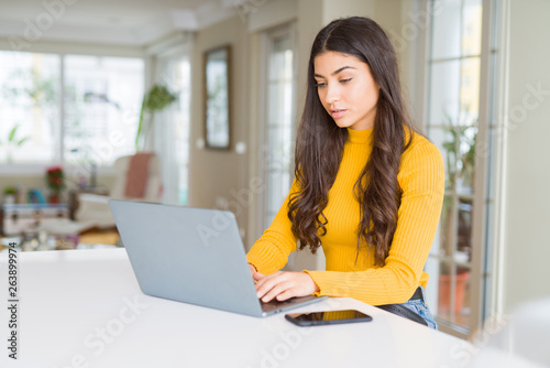 Beauitul young woman working using computer laptop concentrated