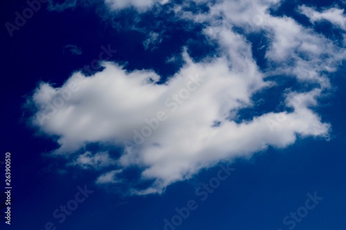 The white clouds in the bright blue sky.