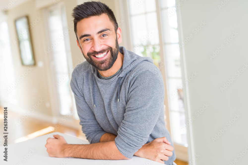 Handsome man smiling cheerful with a big smile on face showing teeth, positive and happy expression