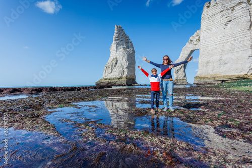 Happy mother with her son having fun in the Etretat. France