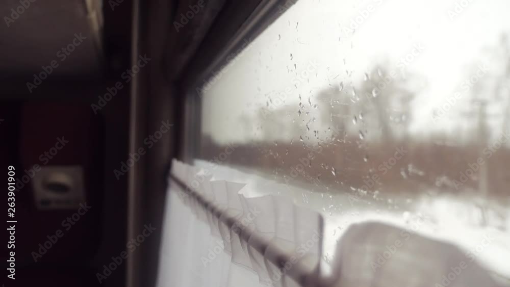 rain snow on glass window. railway concept train journey travel. view beautiful from the window of a moving train railway trip Russia winter lifestyle . slow motion video. interior inside train
