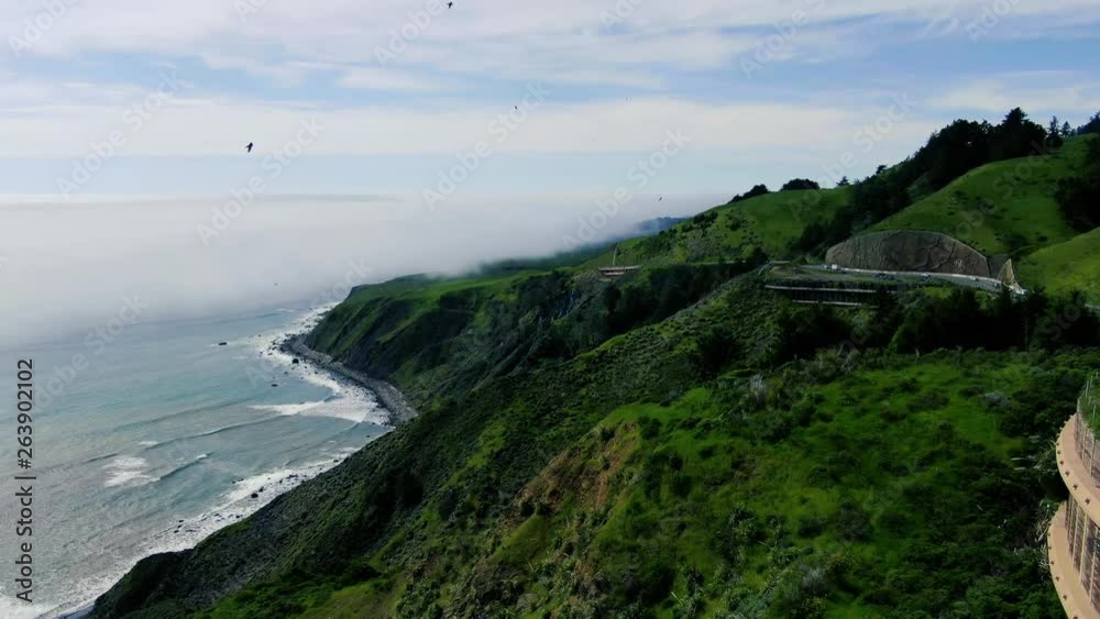 High cliffside aerial video of coastal inversion.