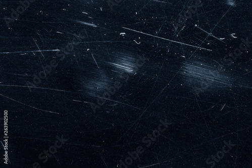 Dust and scratches on black surface. Abstract background. Texture layer for photo editor. Old grunge filter effect.