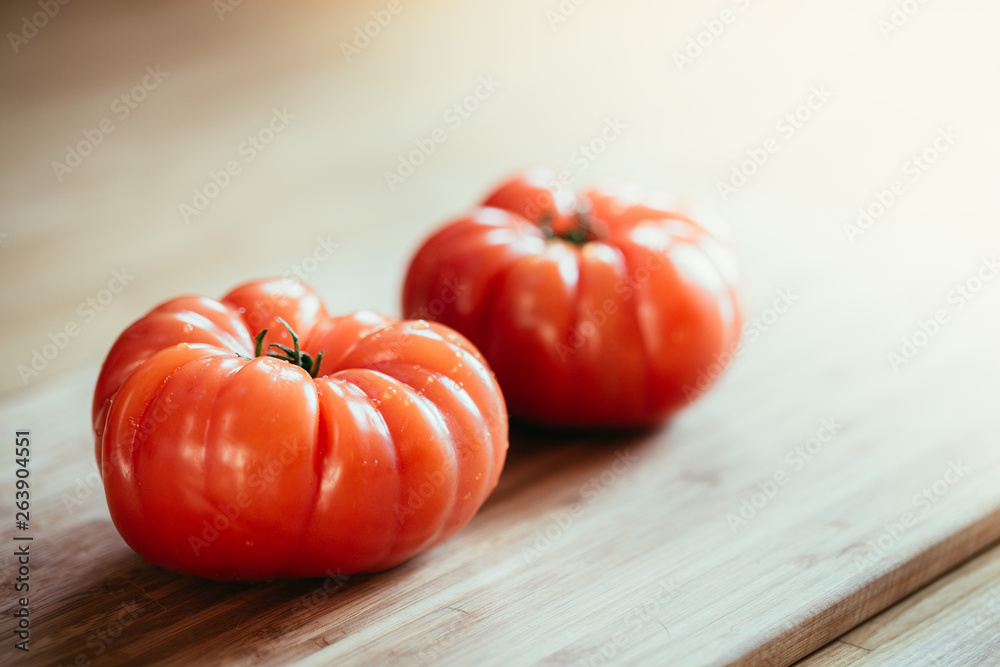 Oxheart tomatoes. Tomatoes on a bamboo wood plate. Oxheart tomatoes. Tomatoes on a bamboo wood plate.