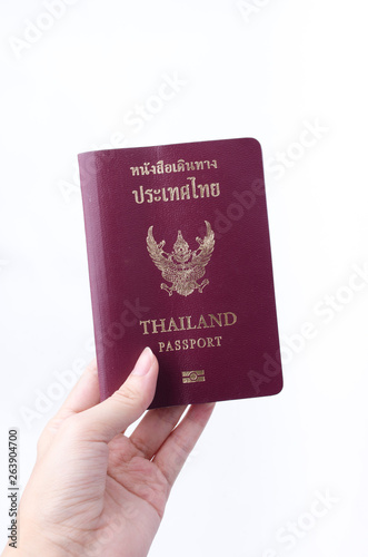 Woman hand holding Thailand passport, isolated on white background.