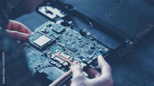 Plakat Computer hardware development. Microelectronics technology science concept. Engineer holding modern motherboard.