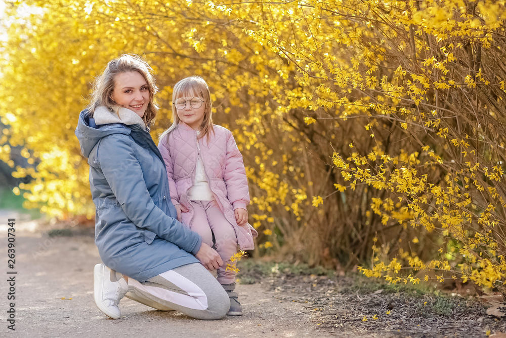 Mother and little daughter playing together in a park Mother and little daughter playing together in a park