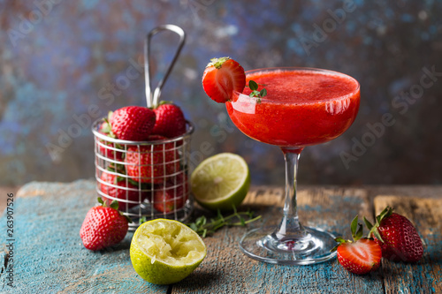 Ice Strawberry alcohol cocktail with lime and rum in a glass photo