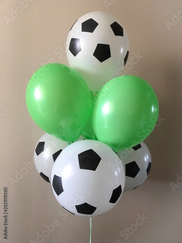 Thematic composition of helium balloons - soccer ball and green football lawn