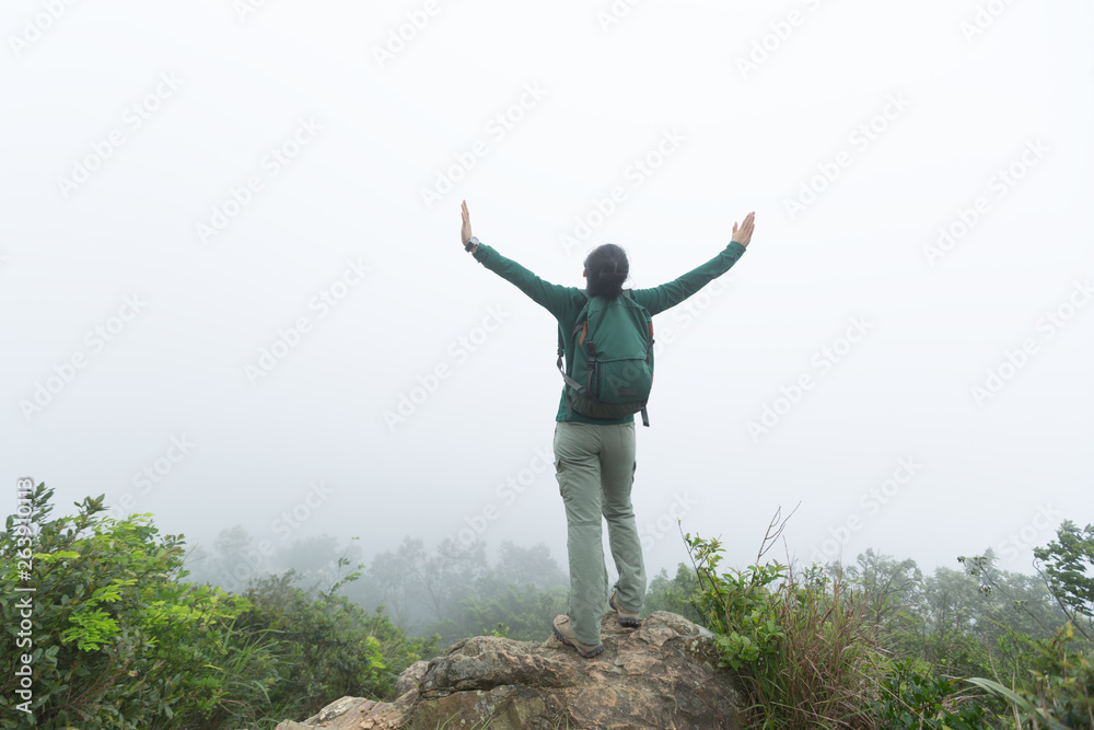 Successful hiker open arms at spring forest mountain top Successful hiker open arms at spring forest mountain top