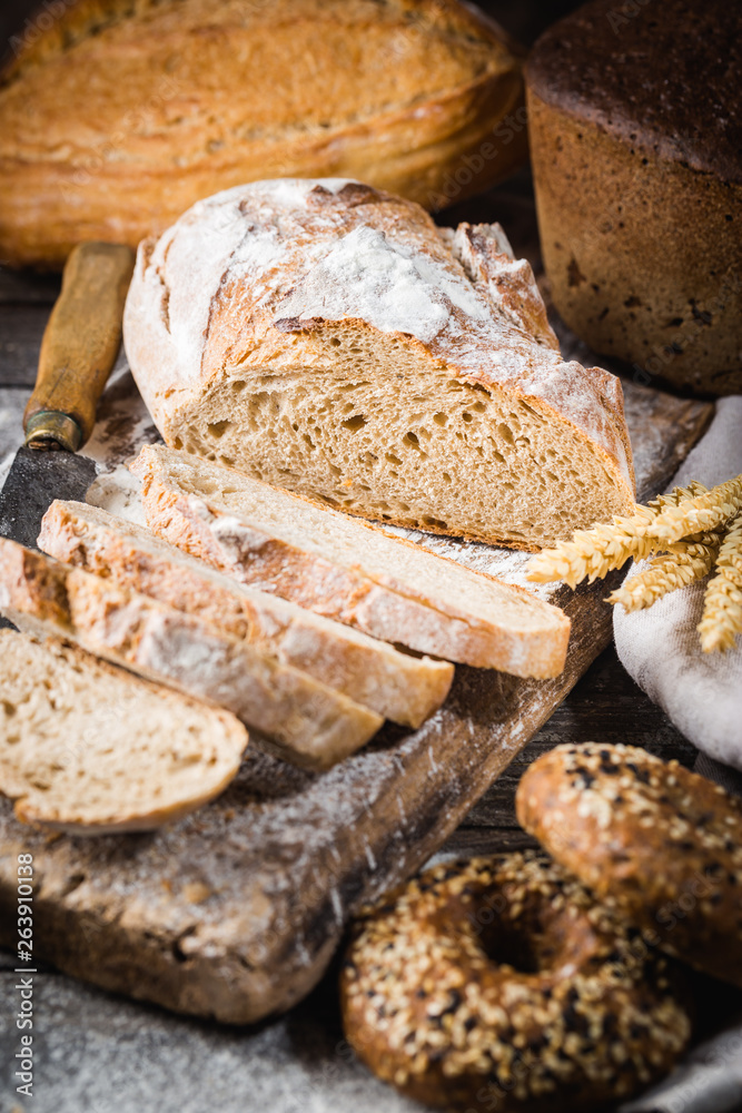 Fresh homemade slice bread and knife on rustic table