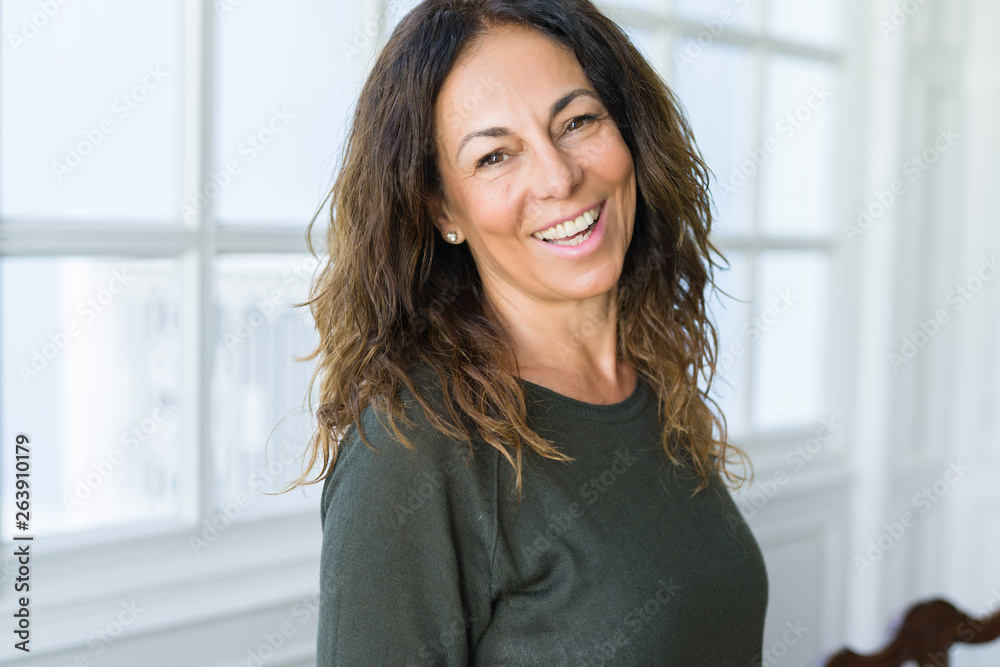 Beautiful middle age woman at home smiling cheerful Beautiful middle age woman at home smiling cheerful