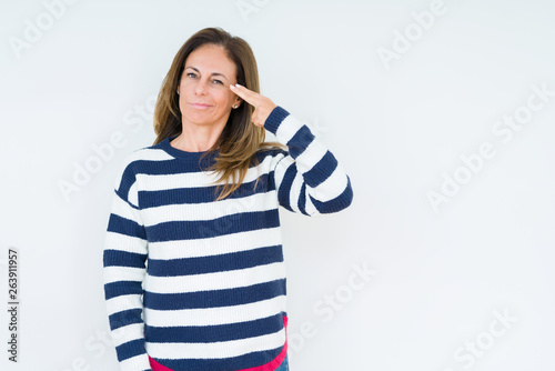 Beautiful middle age woman wearing navy sweater over isolated background Shooting and killing oneself pointing hand and fingers to head, suicide gesture. © Krakenimages.com