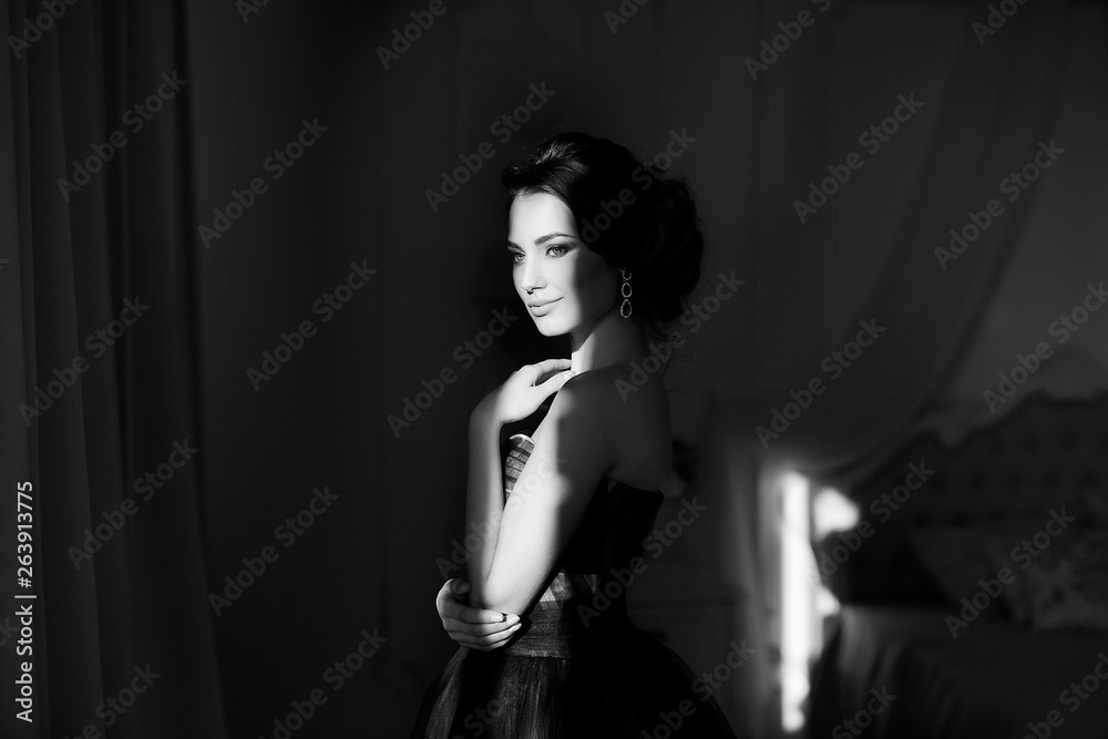 Monochrome portrait of sad brunette woman in sun light with blinds shadow. Monochrome portrait of sad brunette woman in sun light with blinds shadow.