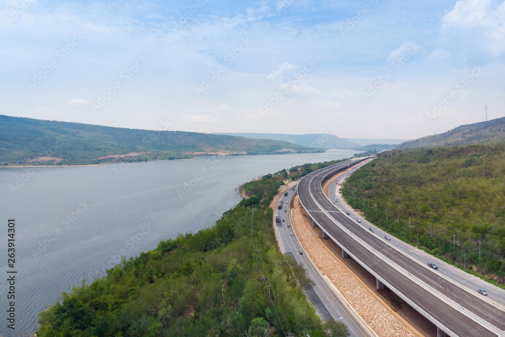 Drone shot aerial view landscape of under construction motorway tolls near big natural river