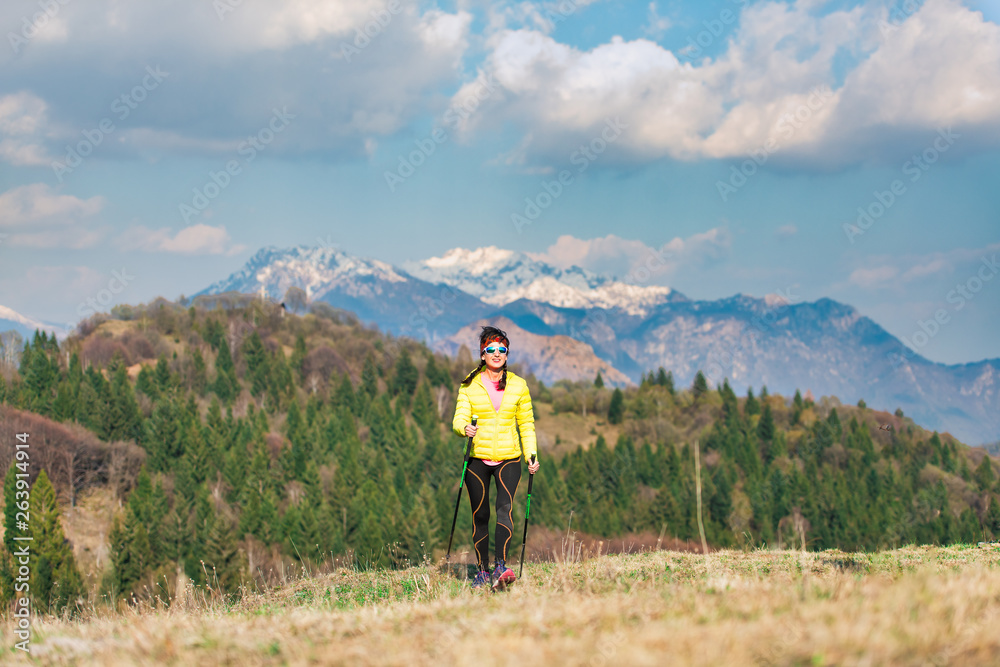 A lonely girl during a trek in the mountains in spring