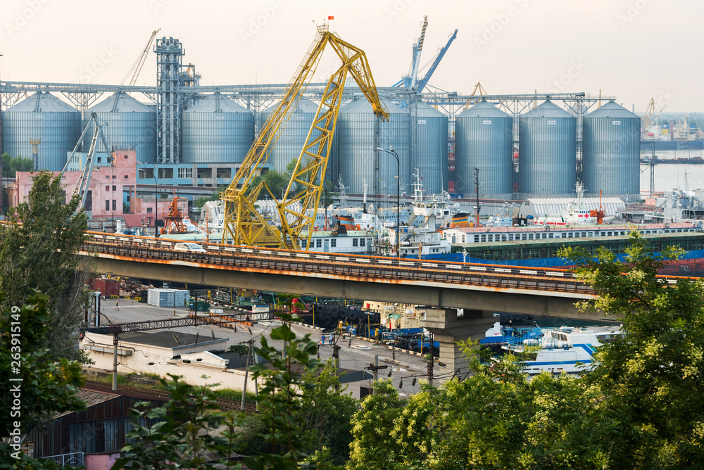 a granary in the port is a marine shipping port in the city of ODESSA, Ukraine. Cranes unloading and loading