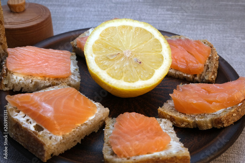 Small sandwiches on homemade bread with butter and red fish