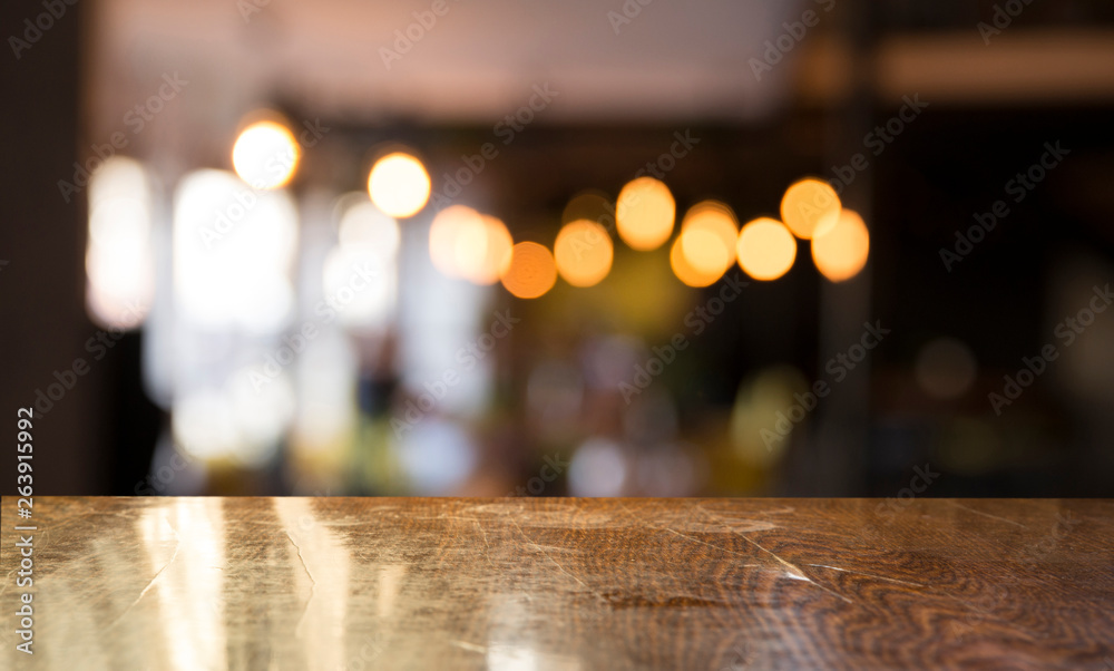 Empty wooden table in front of abstract blurred background of coffee shop . can be used for display or montage your products.Mock up for display of product