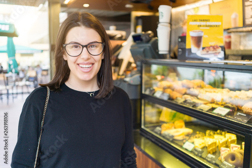 Beautiful young woman smiling at the town