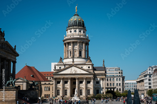People at the French Cathedral at Gendarmenmarkt on a sunny summer day in Berlin