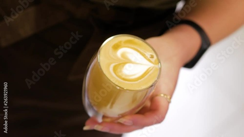 Professional barista making pouring stream milk with beautiful latte art pattern, top view.