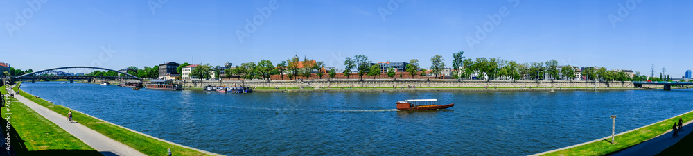 wooden boat goes along the river in Krakow