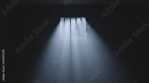a prison dark room window with light rays