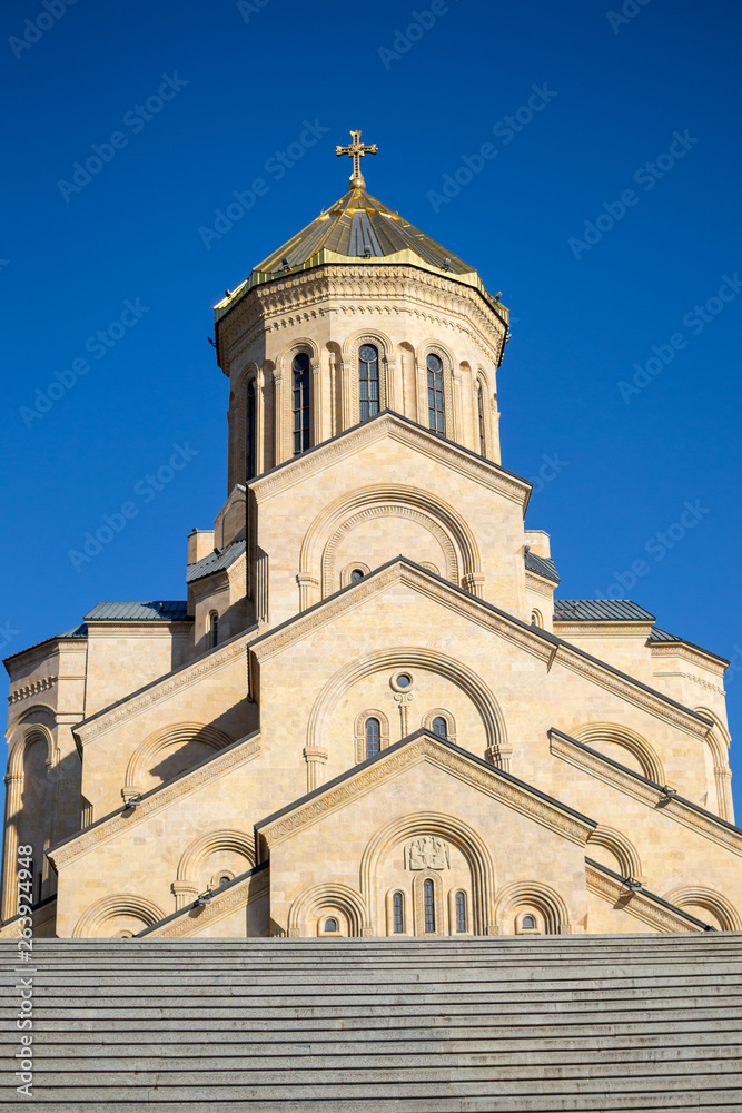 Tsminda Sameba or The Holy Trinity Cathedral of Tbilisi, Georgia in clear weather, bottom view from stairs