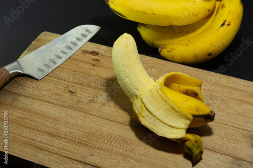 conceptual shot of banana peeled and knife