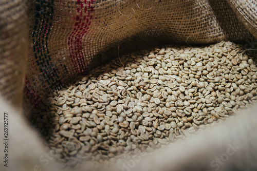 Roaster machine prepared coffee beans.  Process of coffee roasting in cafe. Ingridient for popular european drink. Brown bean inside box. Organic food. Close up shot.