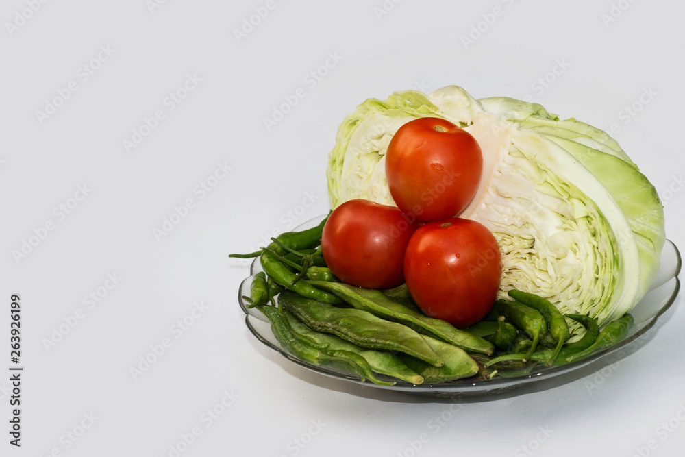 Close up on Fresh cabbage , beans, Green Chilli and Cherry tomato Organic vegetable background in freshness atmosphere Close up on Fresh cabbage , beans, Green Chilli and Cherry tomato Organic vegetable background in freshness atmosphere