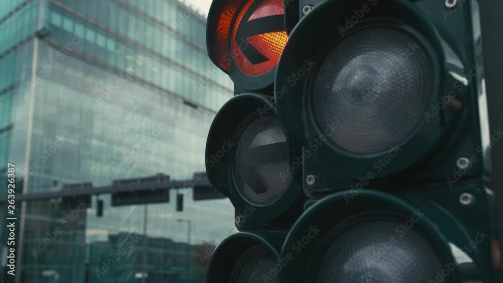 Slow Motion A typical traffic light at the Crossroads in the center of the capital of Germany, Berlin. the yellow and red lights come on. In the background unrecognized buses and cars are driving