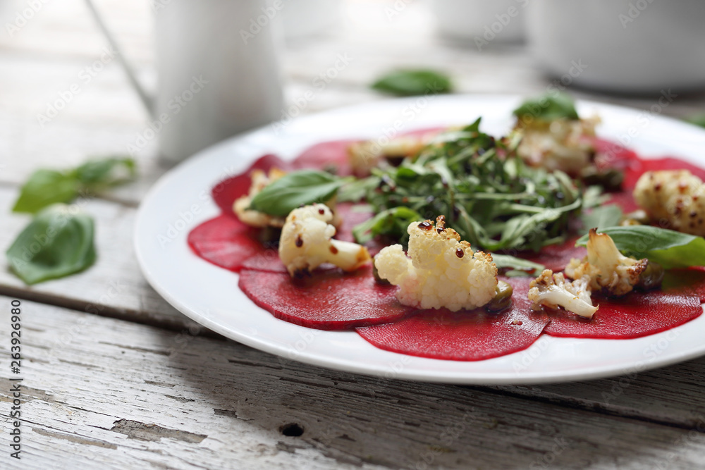 Vegetarian carpaccio of roasted beetroot with cauliflower and green salad. Vegetarian carpaccio of roasted beetroot with cauliflower and green salad.