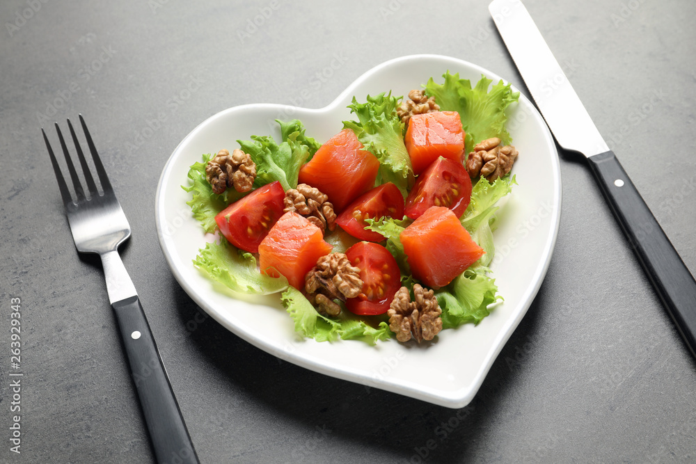 Plate with salad on grey background. Heart-healthy diet Plate with salad on grey background. Heart-healthy diet