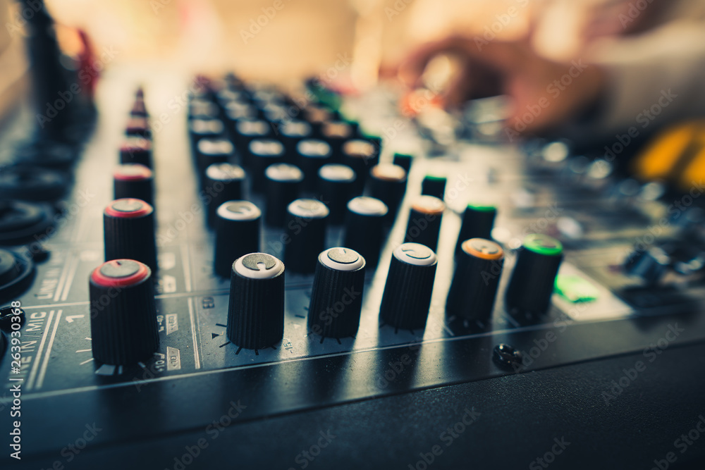 Professional audio mixer with knobs and slide bars that are used to adjust the sound with the hands of expert controls. Popular in party and various events. Professional audio mixer with knobs and slide bars that are used to adjust the sound with the hands of expert controls. Popular in party and various events.