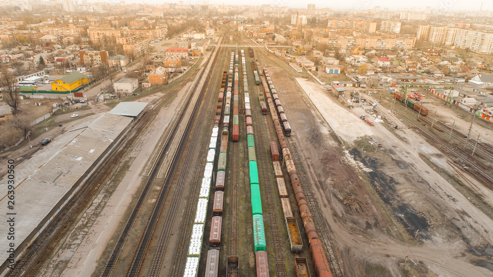 Fototapeta aerial view of city with trains on railway station sun time city