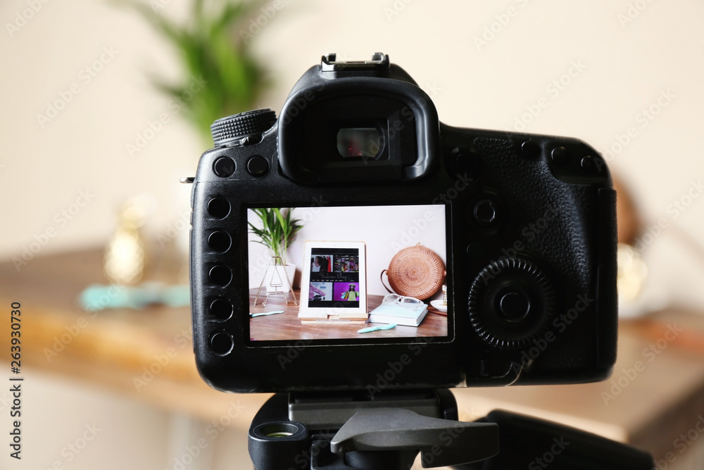 Camera with photo of stylish workplace on screen indoors, selective focus. Fashion blogger Camera with photo of stylish workplace on screen indoors, selective focus. Fashion blogger