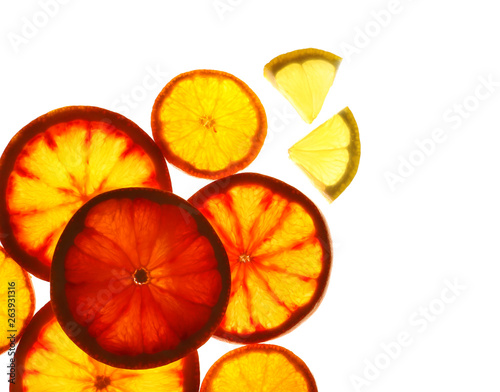 Fototapeta Naklejka Na Ścianę i Meble -  Illuminated slices of citrus fruits on white background, top view