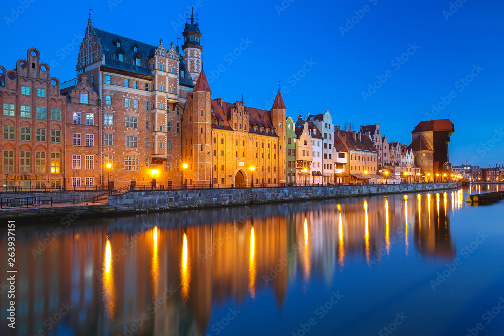 Old town of Gdansk reflected in the Motlawa river at dusk, Poland.