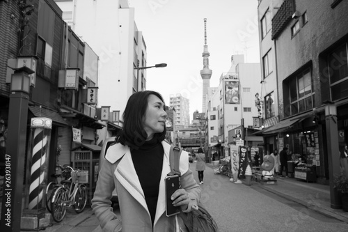 Capture a portrait when strolling on the street of Tokyo,  it's a main thoroughfare in downtown, Tokyo Skytree Tower background, is a broadcast tower, second highest tower in the world.