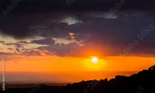 This is a capture of a sunset in Beirut and you can see the orange color formed by the sun and the beautiful horizon photo