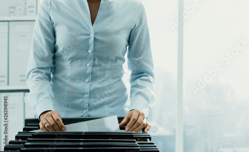 Office worker searching files in the archive photo