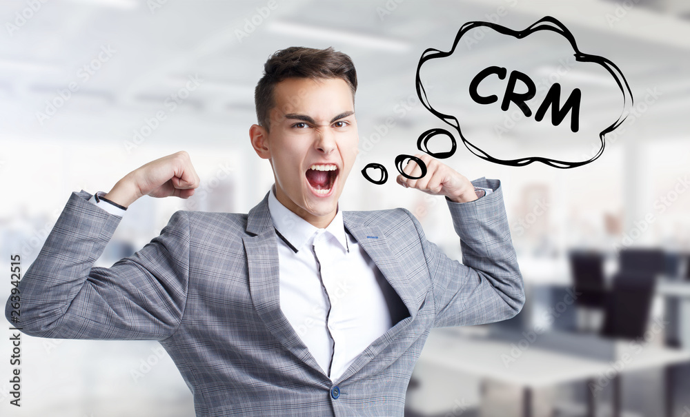 Business, technology, internet and networking concept. Young entrepreneur shouts out a keyword: CRM Business, technology, internet and networking concept. Young entrepreneur shouts out a keyword: CRM