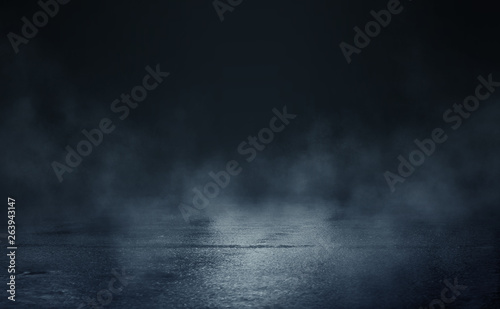 Empty background scene. Dark street reflection on the wet pavement. Rays of blue neon light in the dark, neon figures, smoke. Night view of the street, the city. Abstract dark background.
