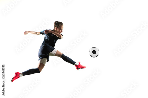 Female soccer player kicking ball isolated over white background © master1305